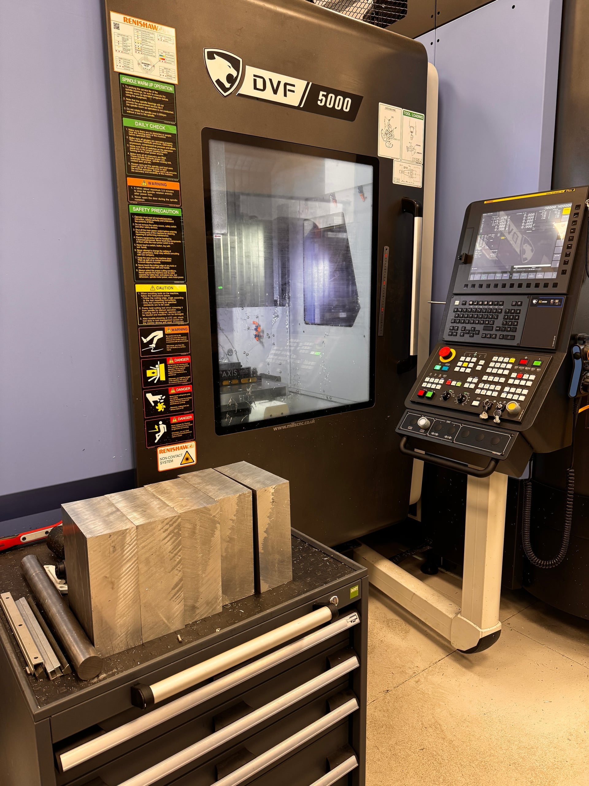 Op 1 setup — 6082-T6 aluminum billet fixtured on the 5-axis CNC mill bed