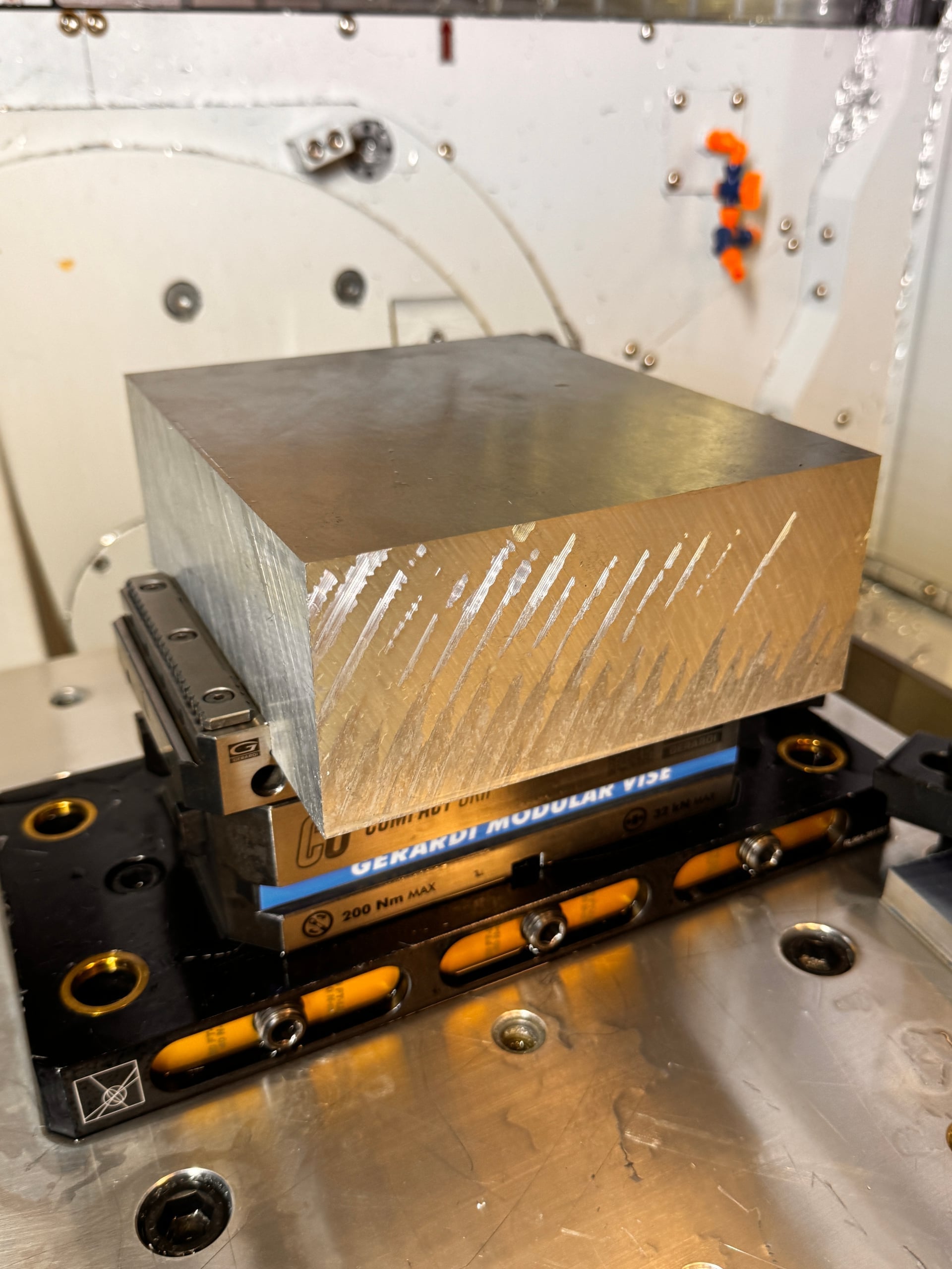 Op 1 roughing — primary outer profile and suspension pickup geometry being cut